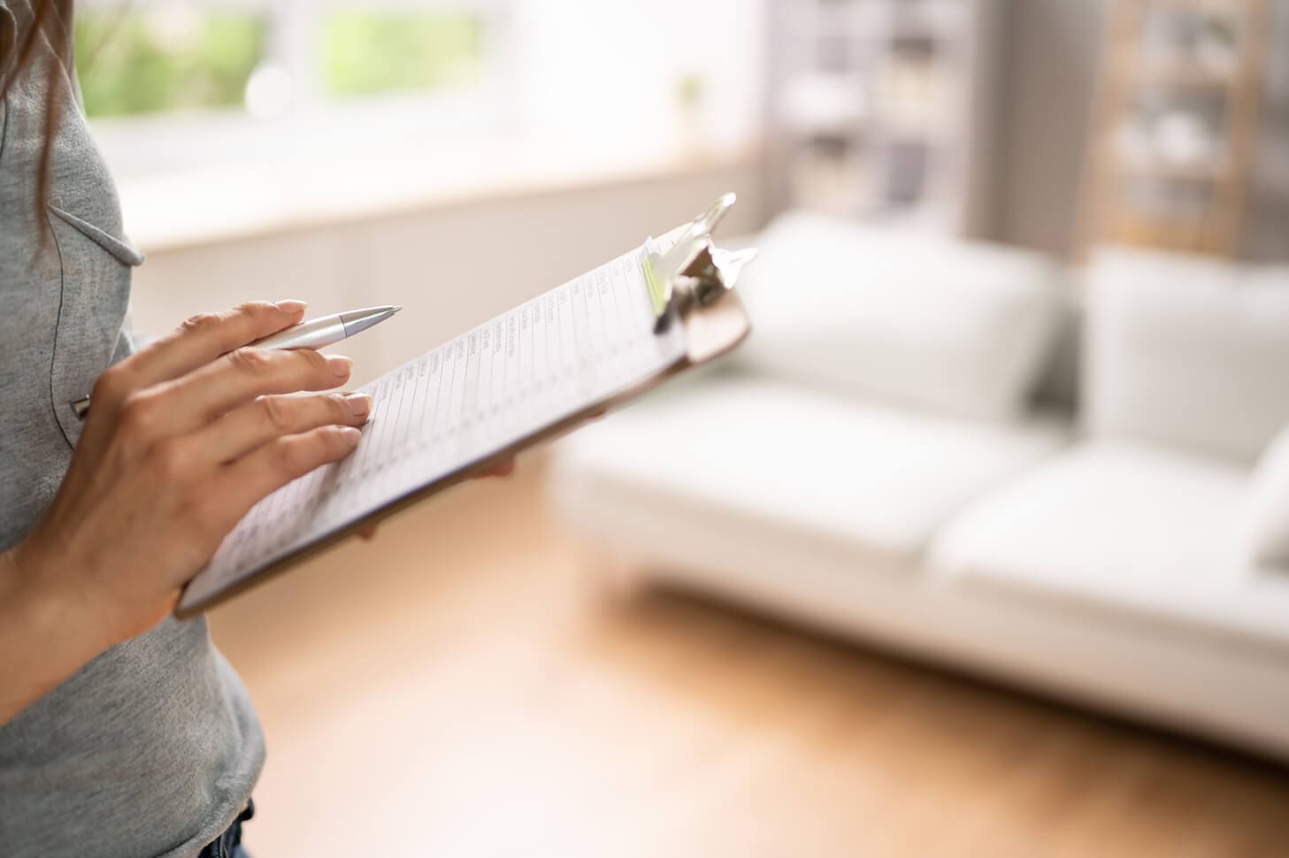 Woman completing a checklist on a clipboard.