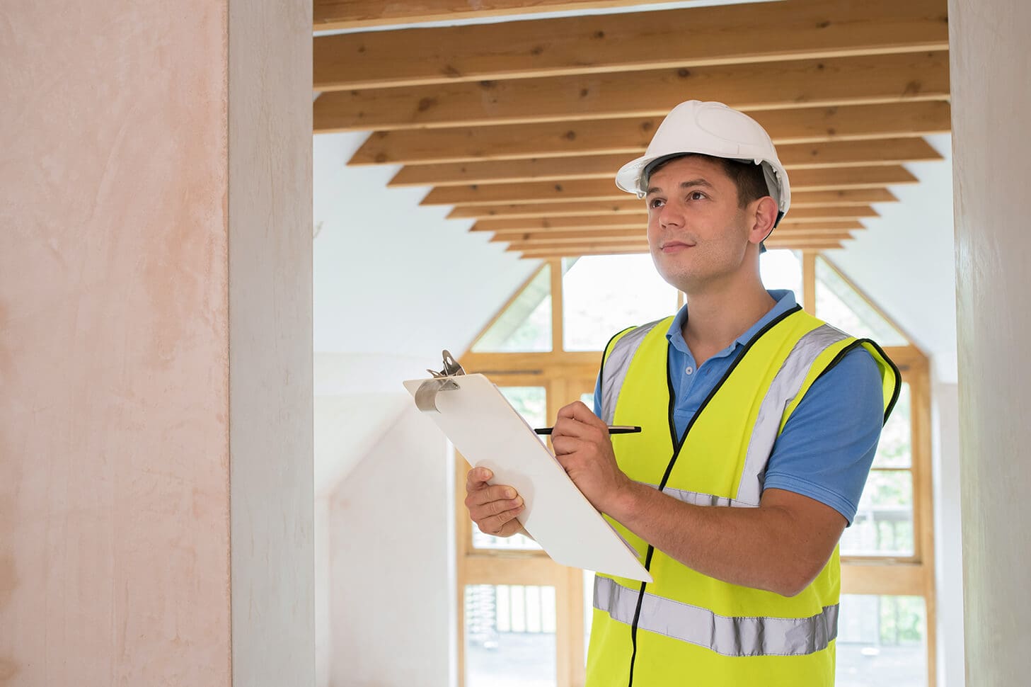 Construction worker inspecting building site.